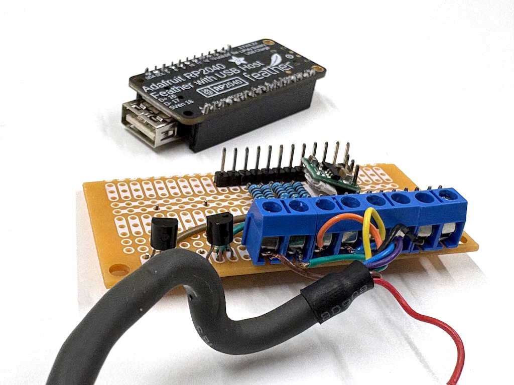 Adafruit Feather RP2040 with USB Type A Host, with headers on top.